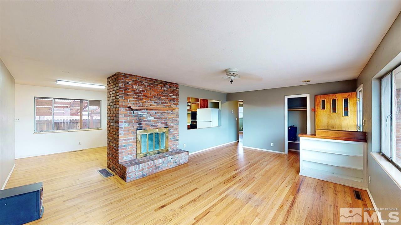 795 Thoma Street Reno, NV 89502 - Photo 4 of 40 a view of a livingroom with wooden floor and a fireplace