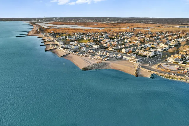 an aerial view of residential building and ocean