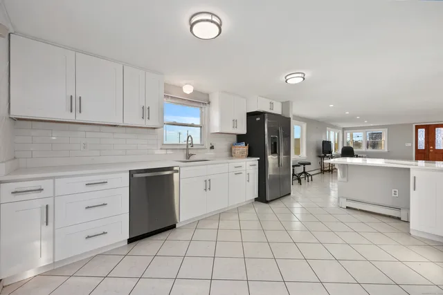 a kitchen with a sink window and cabinets