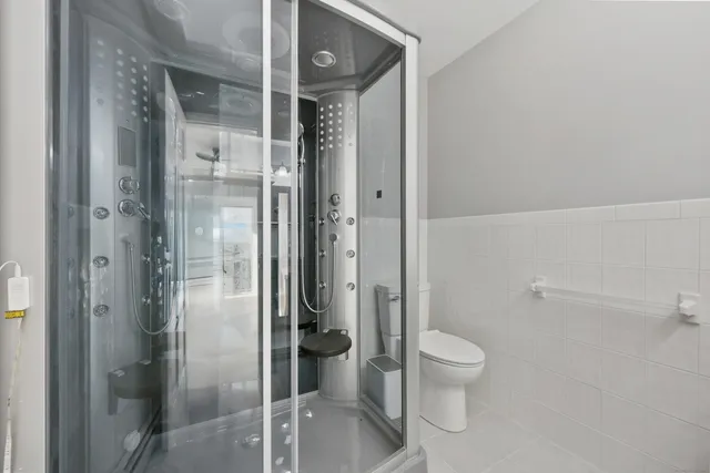 a bathroom with a glass shower door