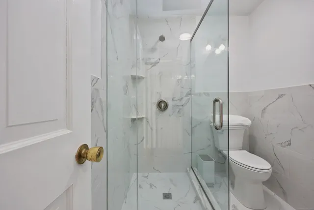 a bathroom with a toilet and shower
