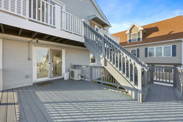 a view of a house with wooden deck