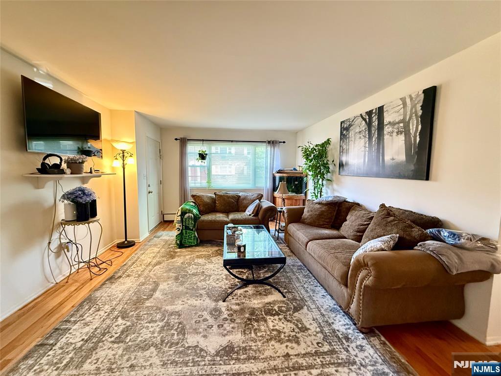1241 Valley Road, Unit 1241A Wayne, NJ 07470 - Photo 2 of 11 a living room with furniture and a flat screen tv