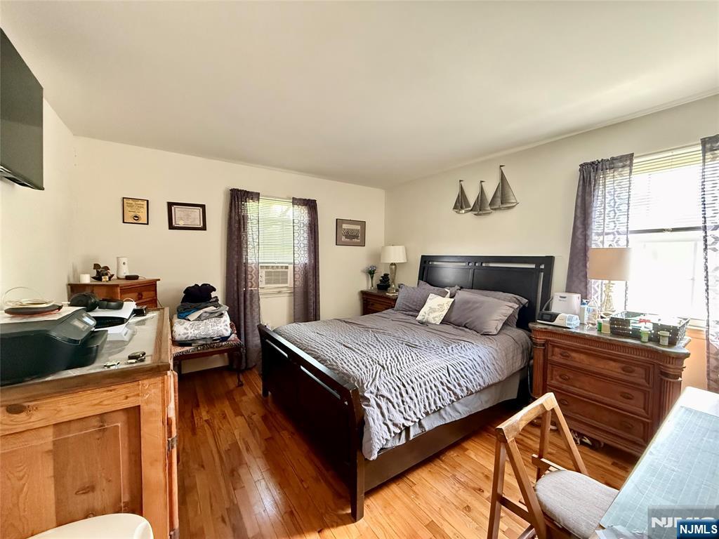 1241 Valley Road, Unit 1241A Wayne, NJ 07470 - Photo 4 of 11 a bedroom with a bed and wooden floor