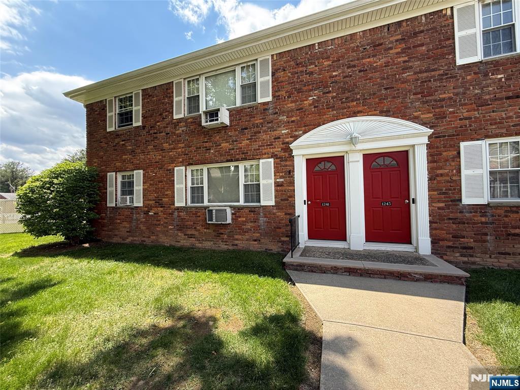 1241 Valley Road, Unit 1241A Wayne, NJ 07470 - Photo 7 of 11 a front view of a house with a yard