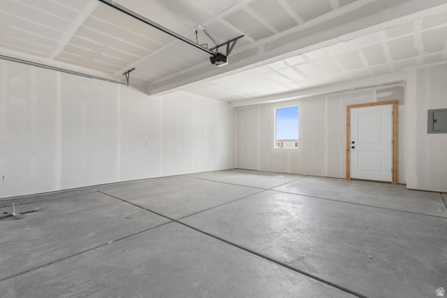 636 West Caroles Way, Unit 7 Tooele, UT 84074 - Photo 29 of 31 Spacious garage featuring a concrete floor, window, and interior access door