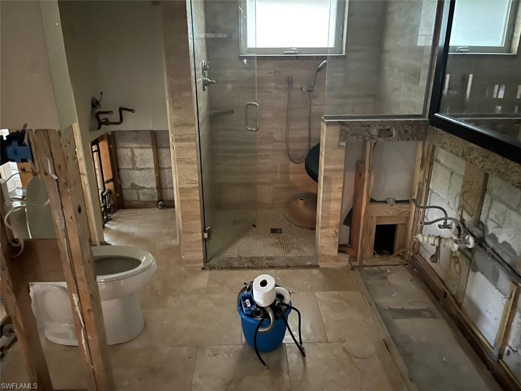 718 Old Trail Drive Naples, FL 34103 - Photo 13 of 18 a bathroom with a granite countertop shower