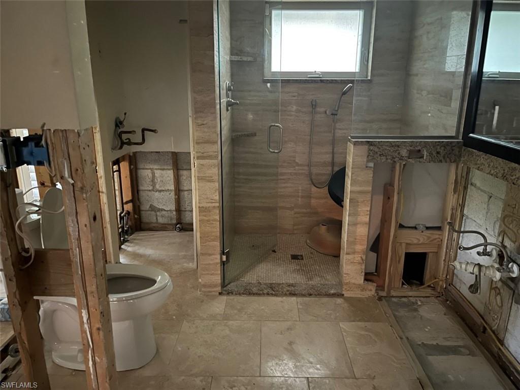 718 Old Trail Drive Naples, FL 34103 - Photo 14 of 18 a bathroom with a shower and mirror