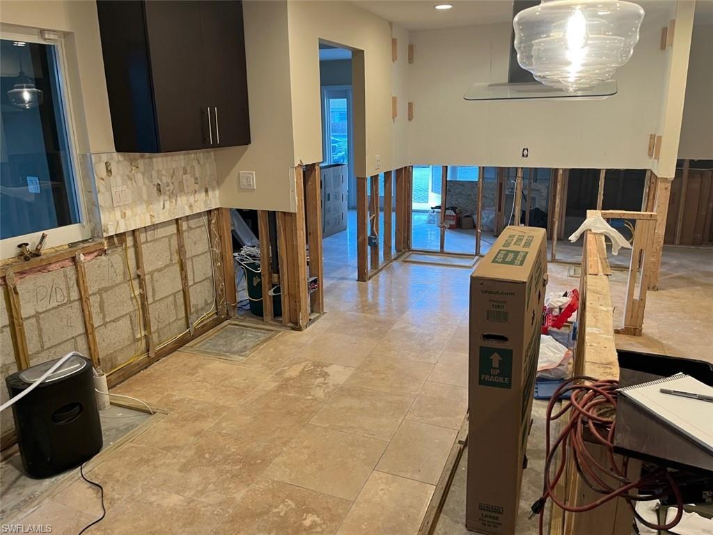 718 Old Trail Drive Naples, FL 34103 - Photo 16 of 18 a kitchen with stainless steel appliances kitchen island granite countertop a refrigerator and a stove