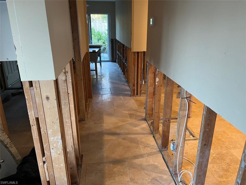 718 Old Trail Drive Naples, FL 34103 - Photo 8 of 18 a view of a hallway with wooden floor and stairs