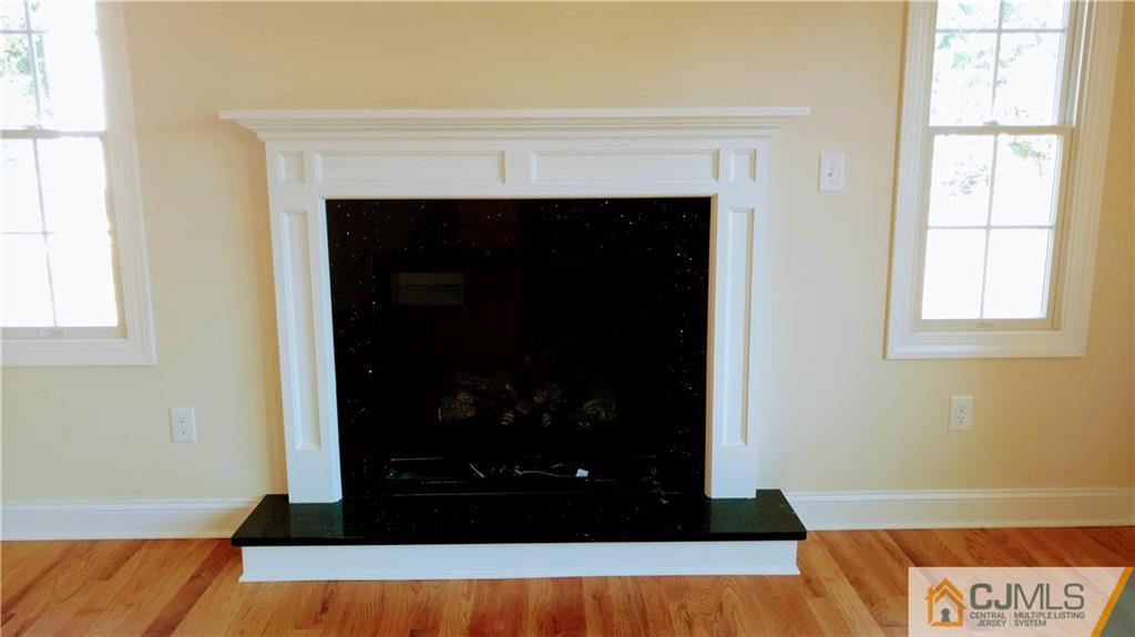 2030 Oak Tree Road Edison, NJ 08820 - Photo 13 of 33 a living room with a fireplace and a window