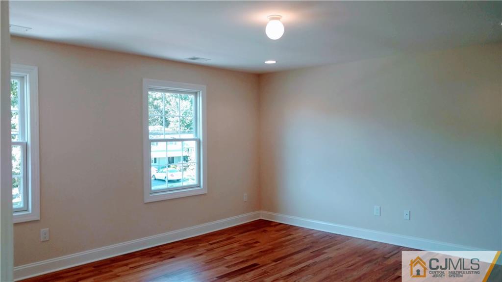 2030 Oak Tree Road Edison, NJ 08820 - Photo 23 of 33 an empty room with wooden floor and windows