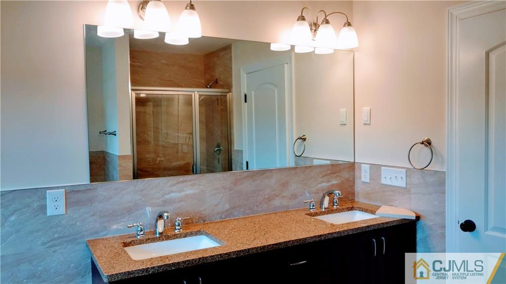 2030 Oak Tree Road Edison, NJ 08820 - Photo 28 of 33 a bathroom with a sink and a mirror