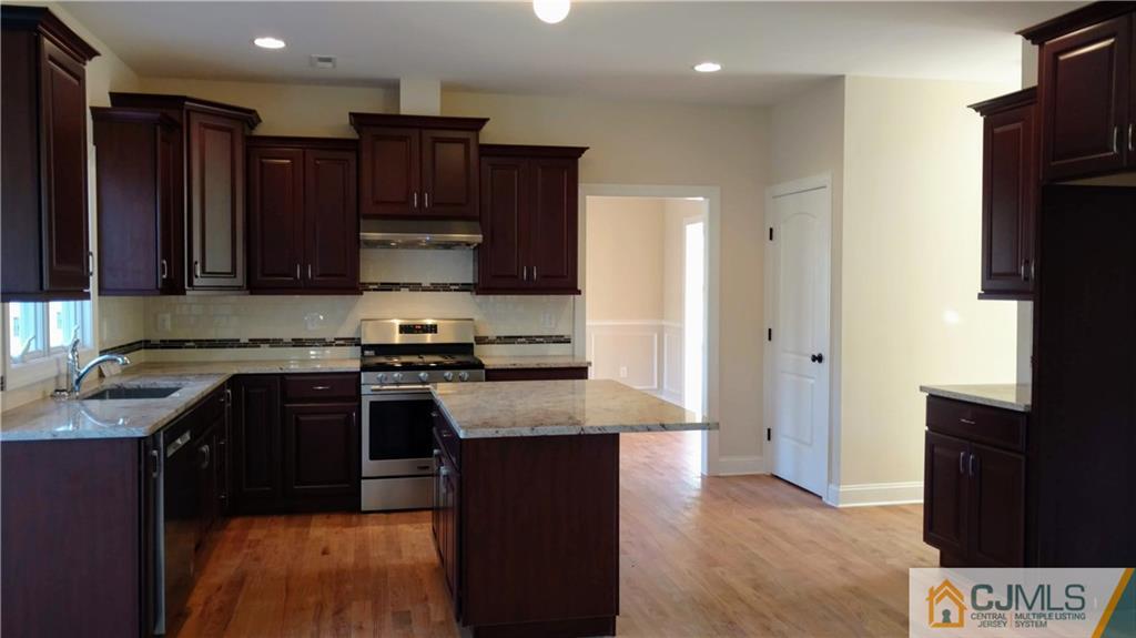 2030 Oak Tree Road Edison, NJ 08820 - Photo 6 of 33 a kitchen with granite countertop stainless steel appliances and wooden cabinets