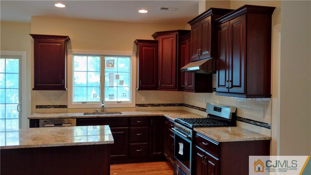 2030 Oak Tree Road Edison, NJ 08820 - Photo 9 of 33 a kitchen with granite countertop stainless steel appliances a sink stove and cabinets