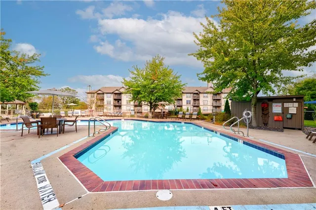 a swimming pool with outdoor seating and yard