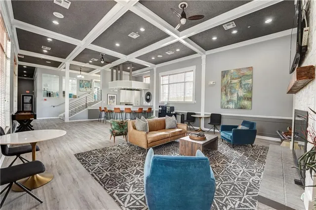 a living room with furniture and a chandelier