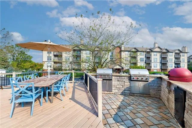 a view of a patio with a table and chairs