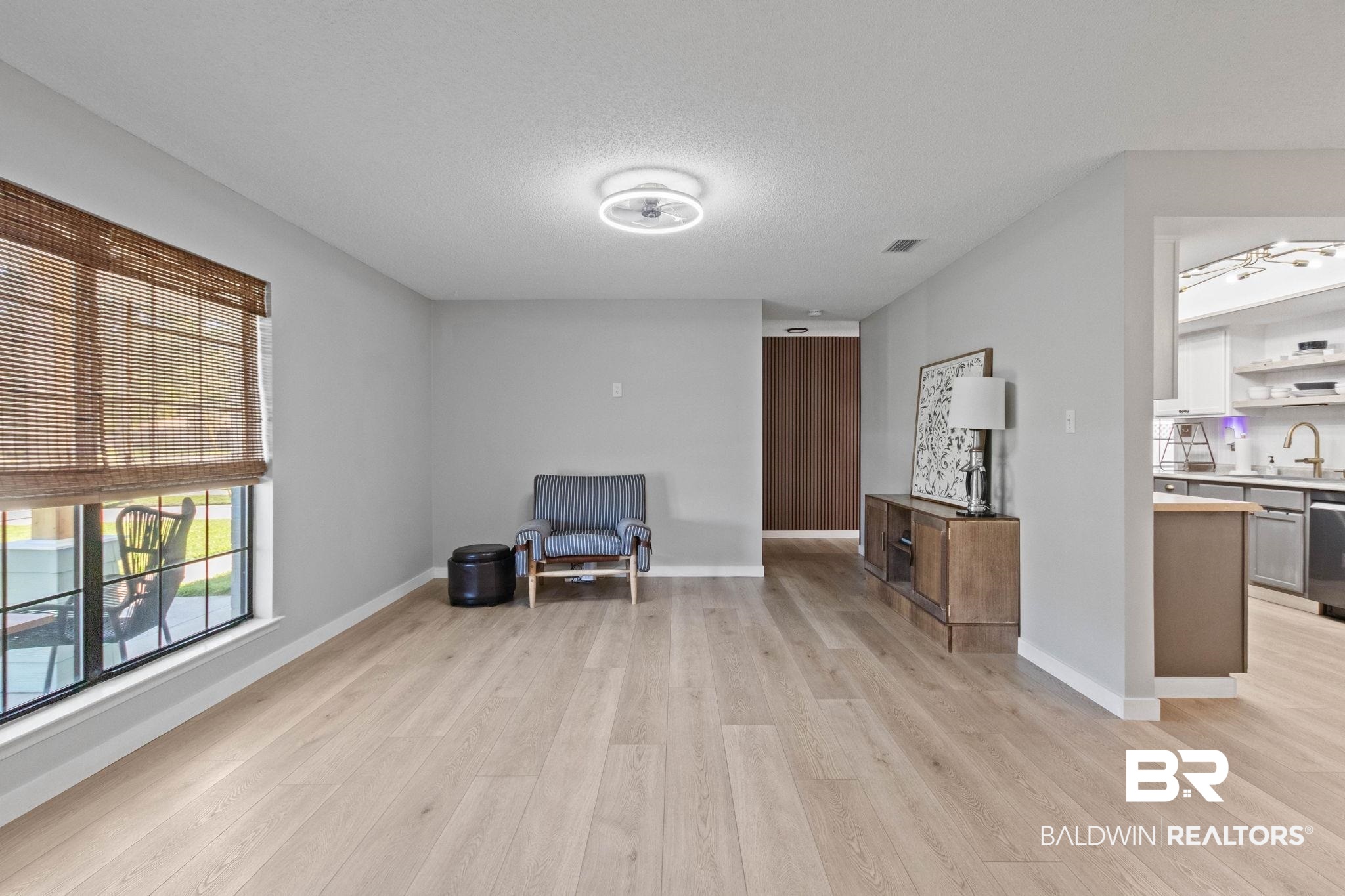 524 Ariel Avenue Foley, AL 36535 - Photo 6 of 37 Spacious interior featuring wide-plank wood-finish flooring, neutral gray wall tones, and a modern ceiling light fixture