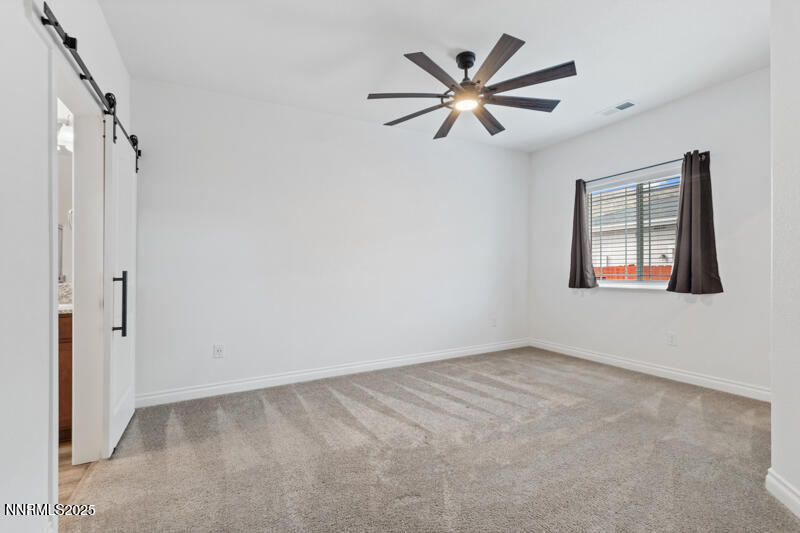18697 Ginny Crk Court Reno, NV 89508 - Photo 11 of 23 an empty room with windows and fan