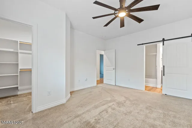 a view of a big room with closet and chandelier fan