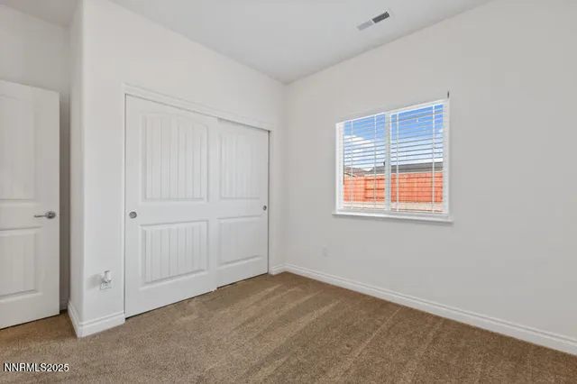 a view of an empty room with closet