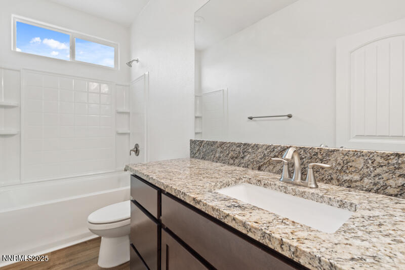 18697 Ginny Crk Court Reno, NV 89508 - Photo 18 of 23 a bathroom with a granite countertop sink toilet and shower