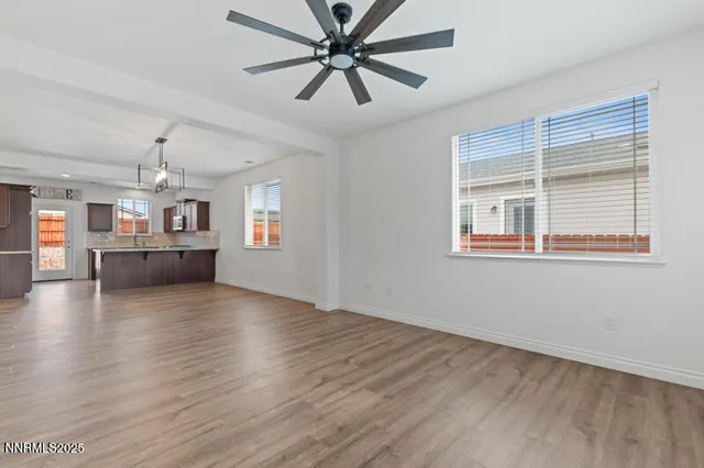a view of a livingroom with a window and wooden floor