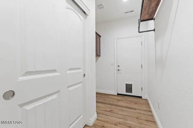a view of a livingroom with wooden floor and cabinet