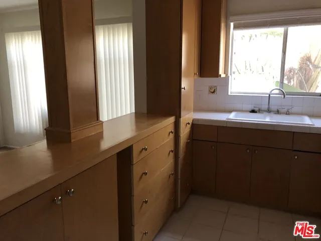 a kitchen with a sink and a window