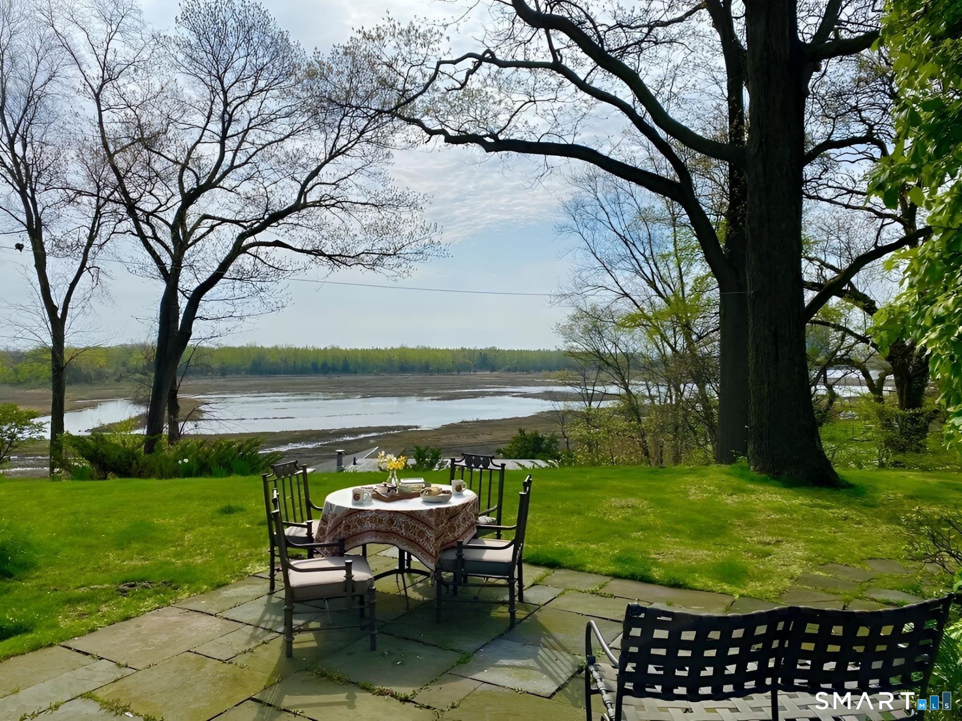 31 Splitrock Road Norwalk, CT 06854 - Photo 1 of 38 a view of a lake with a yard table and chairs