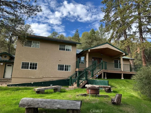a front view of a house with a yard table and chairs