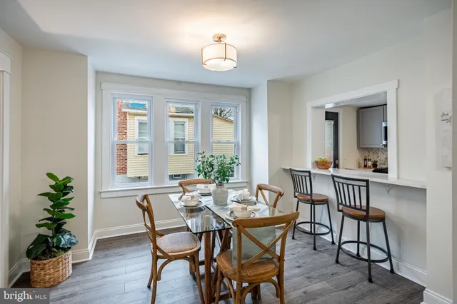 a kitchen with sink a microwave and cabinets