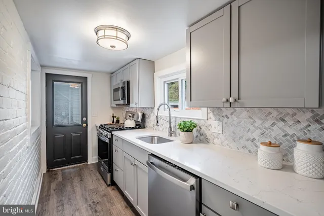 a kitchen that has a sink and a stove