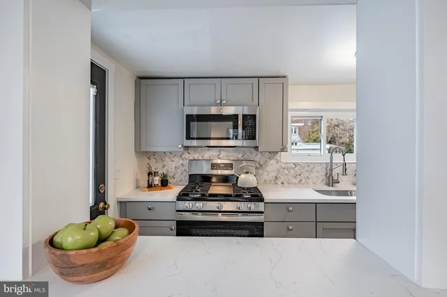 a kitchen with a stove and a refrigerator