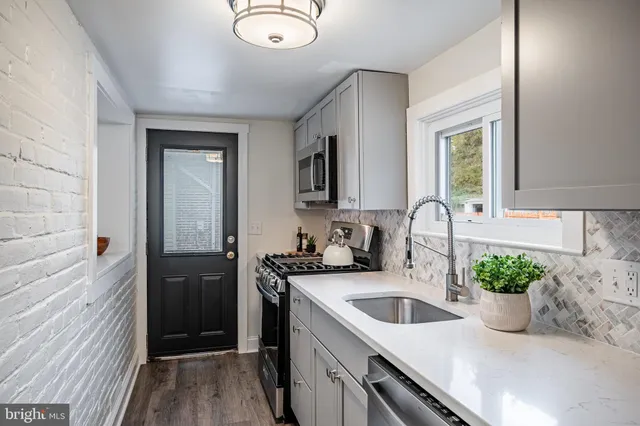 a kitchen with a sink stove and refrigerator