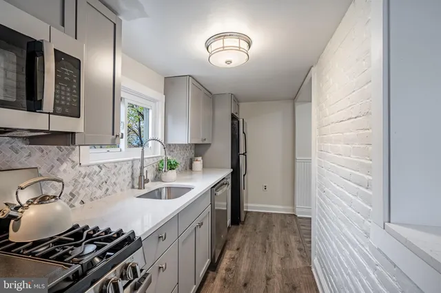 a view of a dining room and kitchen with furniture window and wooden floor