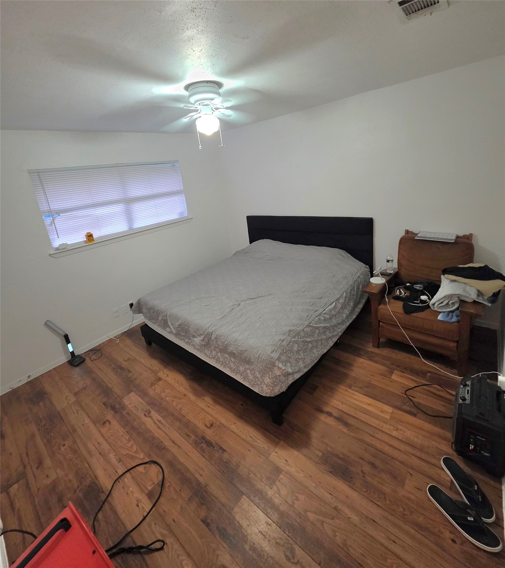 15208 Spring Hill Lane, Unit A Pflugerville, TX 78660 - Photo 12 of 16 Bedroom featuring wood-finish flooring, a window with blinds, and a ceiling fan with integrated lighting