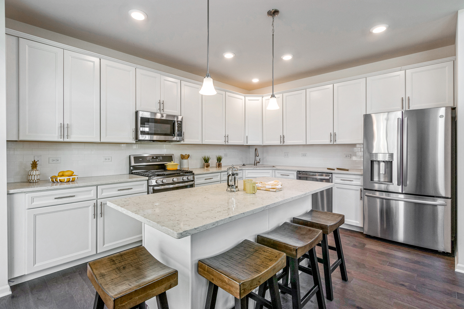 2065 Stuttle Road Batavia, IL 60510 - Photo 11 of 23 a kitchen with stainless steel appliances a stove a sink a refrigerator a microwave and wooden cabinets