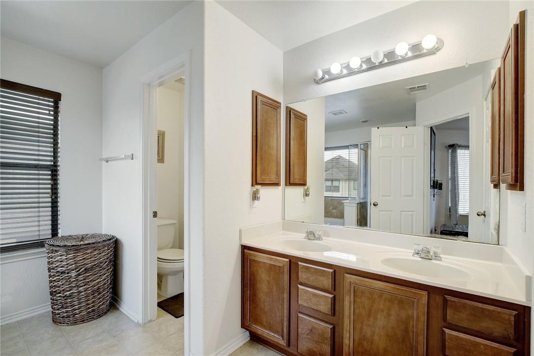 356 Matthews Kyle, TX 78640 - Photo 12 of 30 Double vanity with ample storage and bright lighting enhance this well-appointed bathroom.