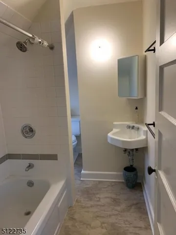 a bathroom with a sink a mirror and a bathtub