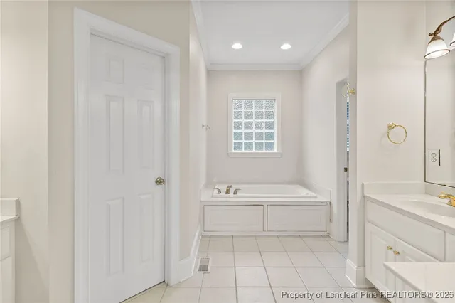 a bathroom with a bathtub a sink and a mirror