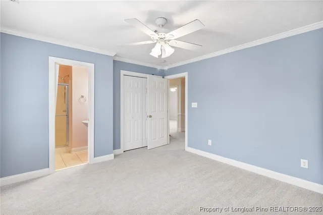 a view of a room with a ceiling fan and a window