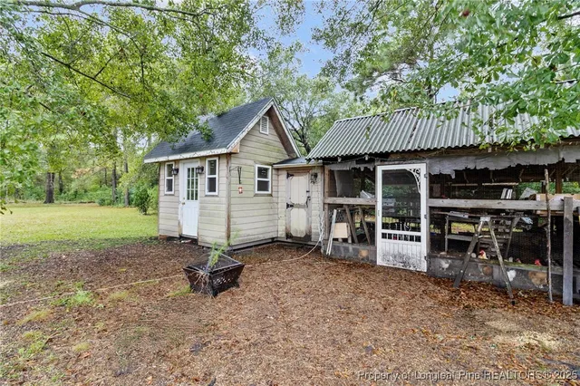 a view of a house with backyard porch and sitting area
