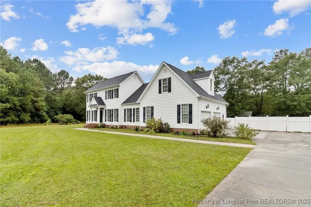 a front view of house with yard and green space