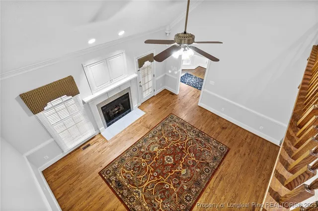 wooden floor in an empty room with a fireplace