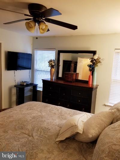 1810 Waltman Road Edgewood, MD 21040 - Photo 19 of 42 a bedroom with a large bed and a flat tv screen on a dresser