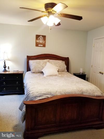 1810 Waltman Road Edgewood, MD 21040 - Photo 20 of 42 a bedroom with a bed and a chandelier