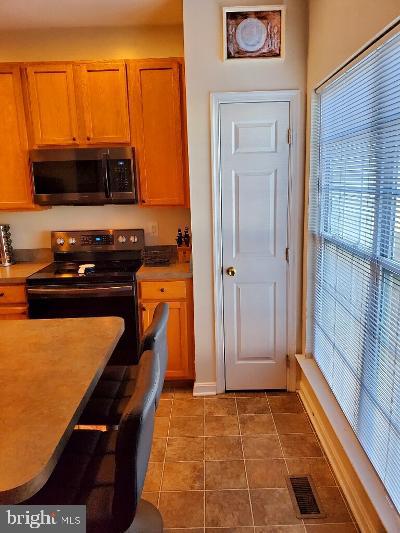 1810 Waltman Road Edgewood, MD 21040 - Photo 8 of 42 a kitchen with stainless steel appliances a refrigerator and a stove top oven