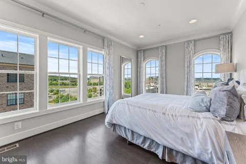 a bedroom with a large bed and a large window